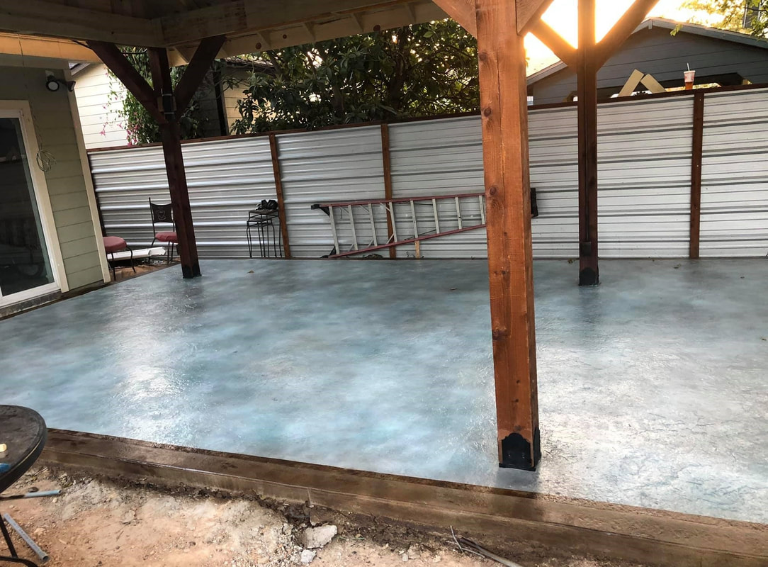 textured stained concrete driveway under a carport in carlisle pa